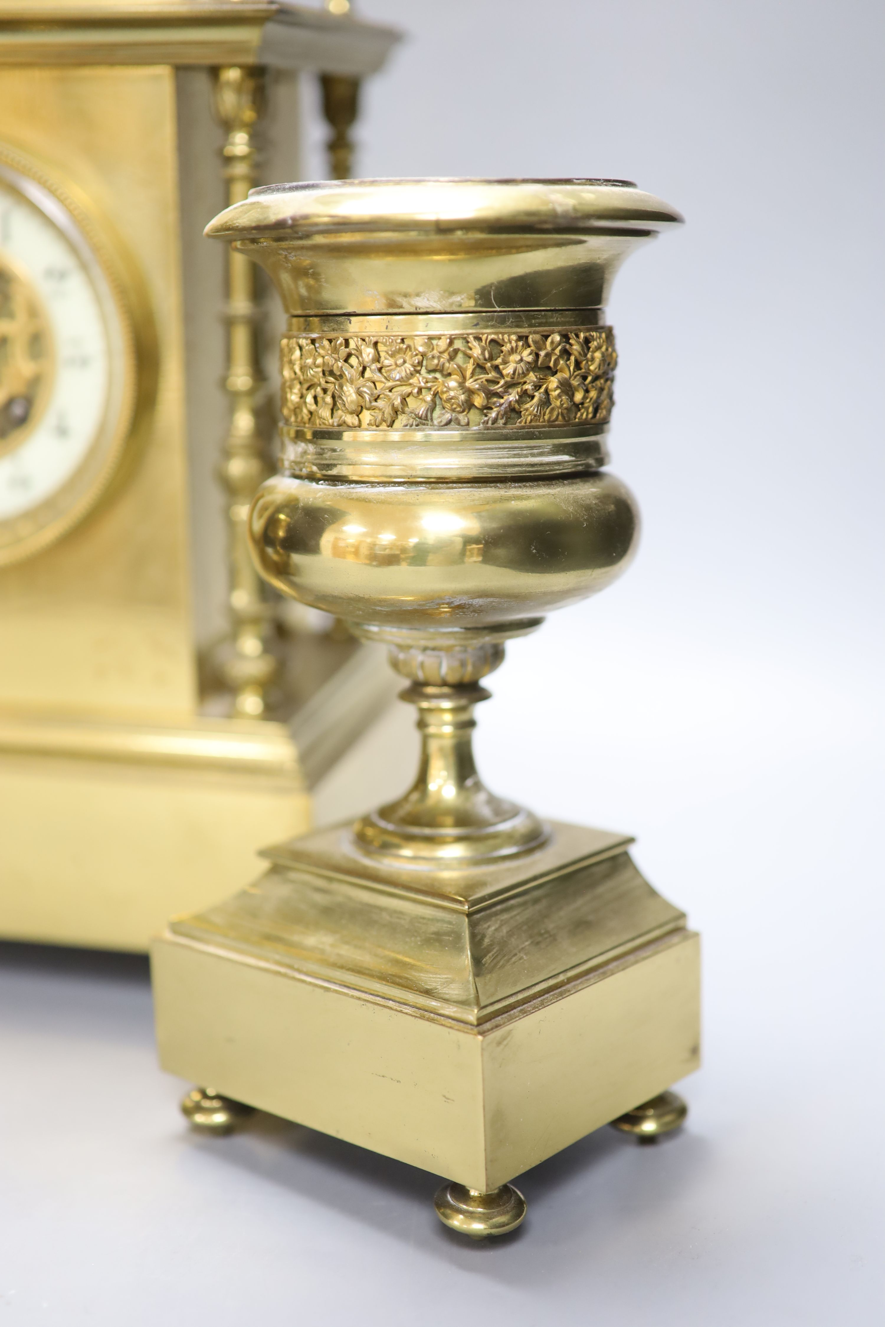 A late 19th century gilt brass three piece clock garniture, the clock with an eight day striking movement, height 39cm